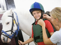 Girl putting on helmet